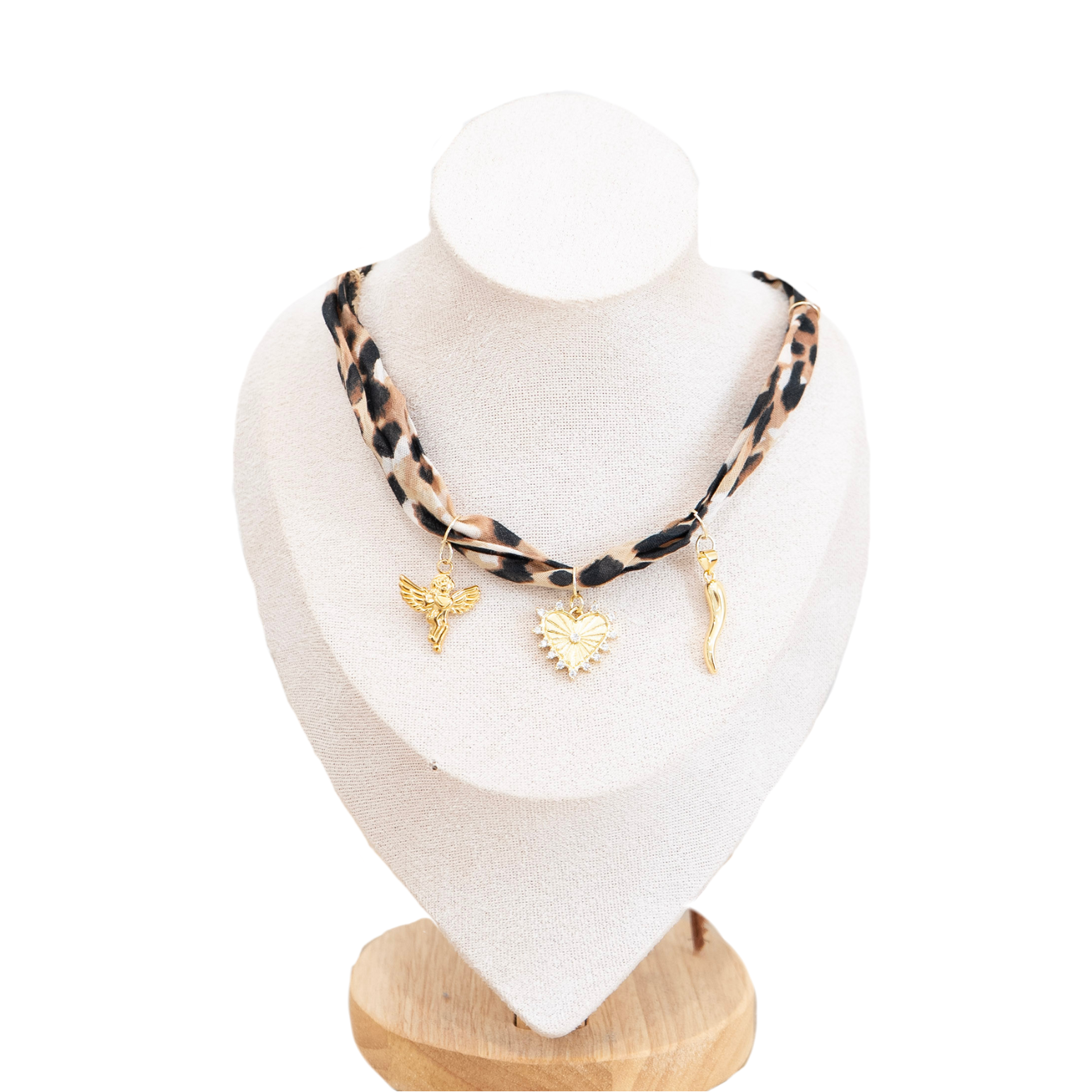 A leopard-print necklace with gold-toned charms, displayed on a white fabric mannequin bust against a white background.