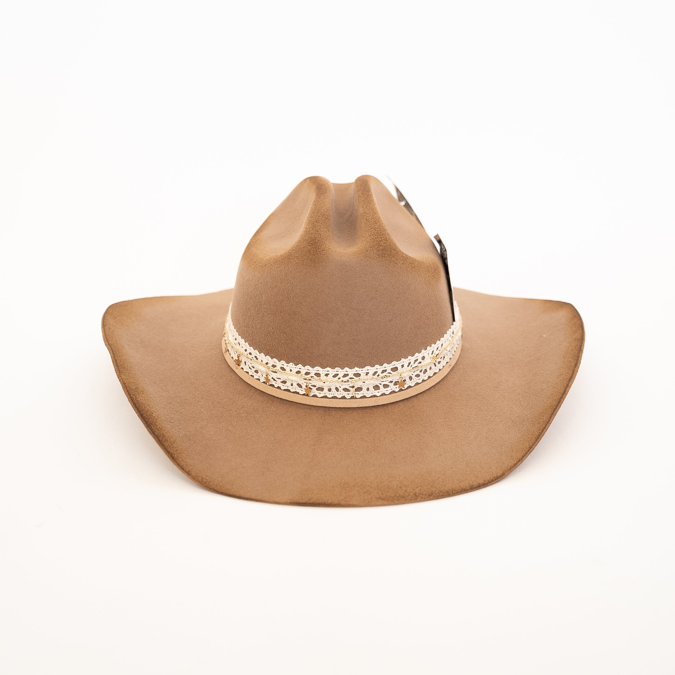 Brown cowboy hat with decorative band on a white background