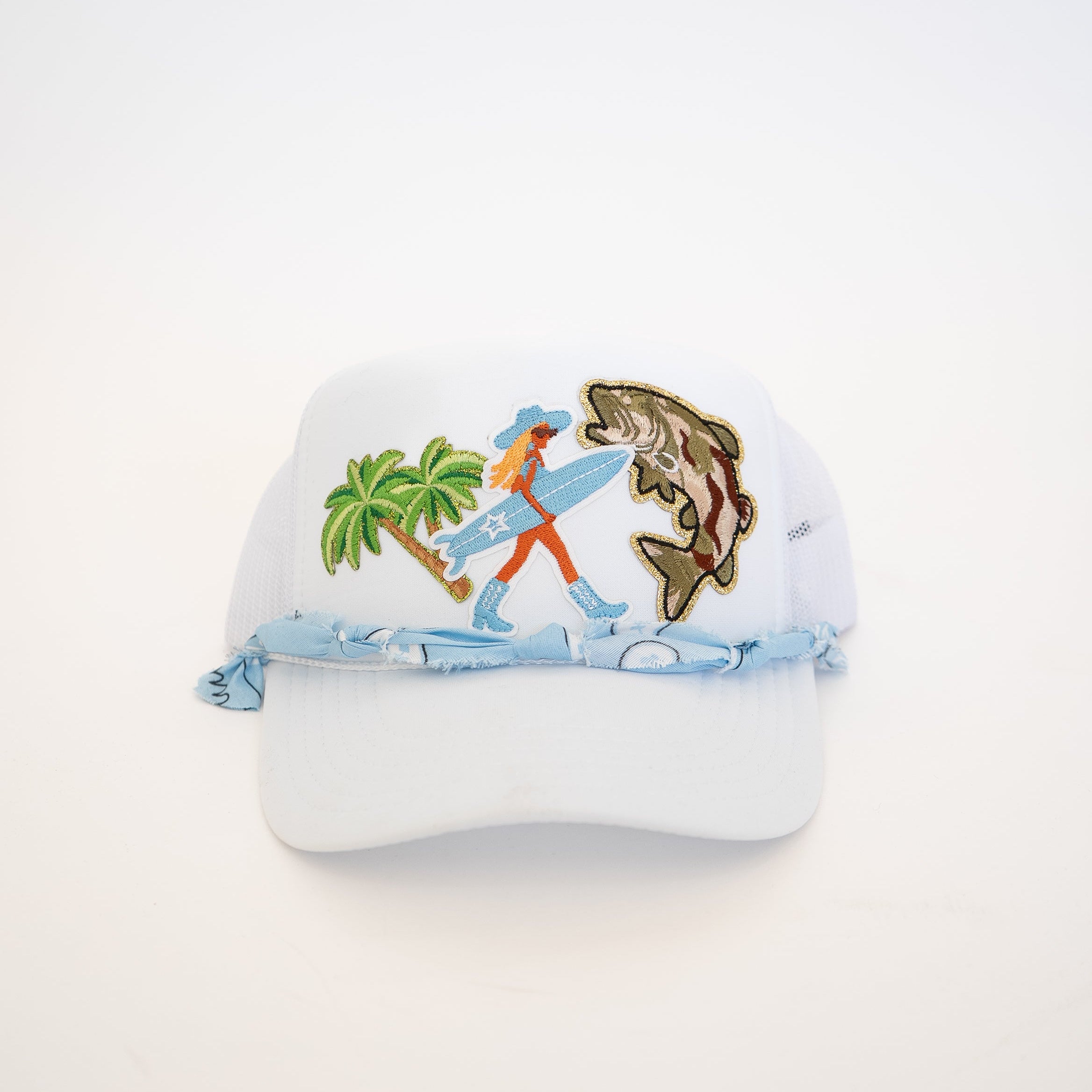 Cap with a design of a person surfing and a fish on a white background