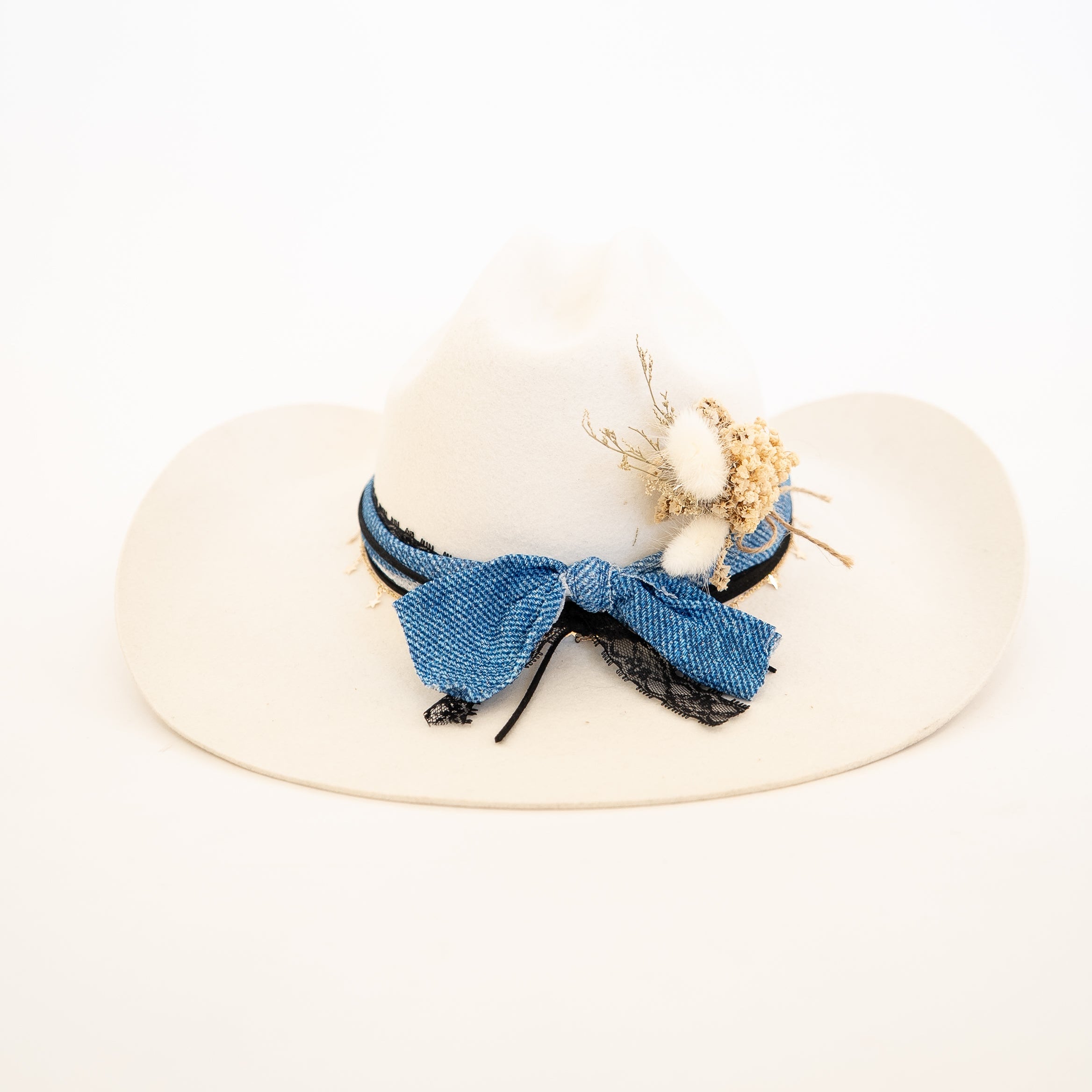 White hat with blue decorative bow on a white background