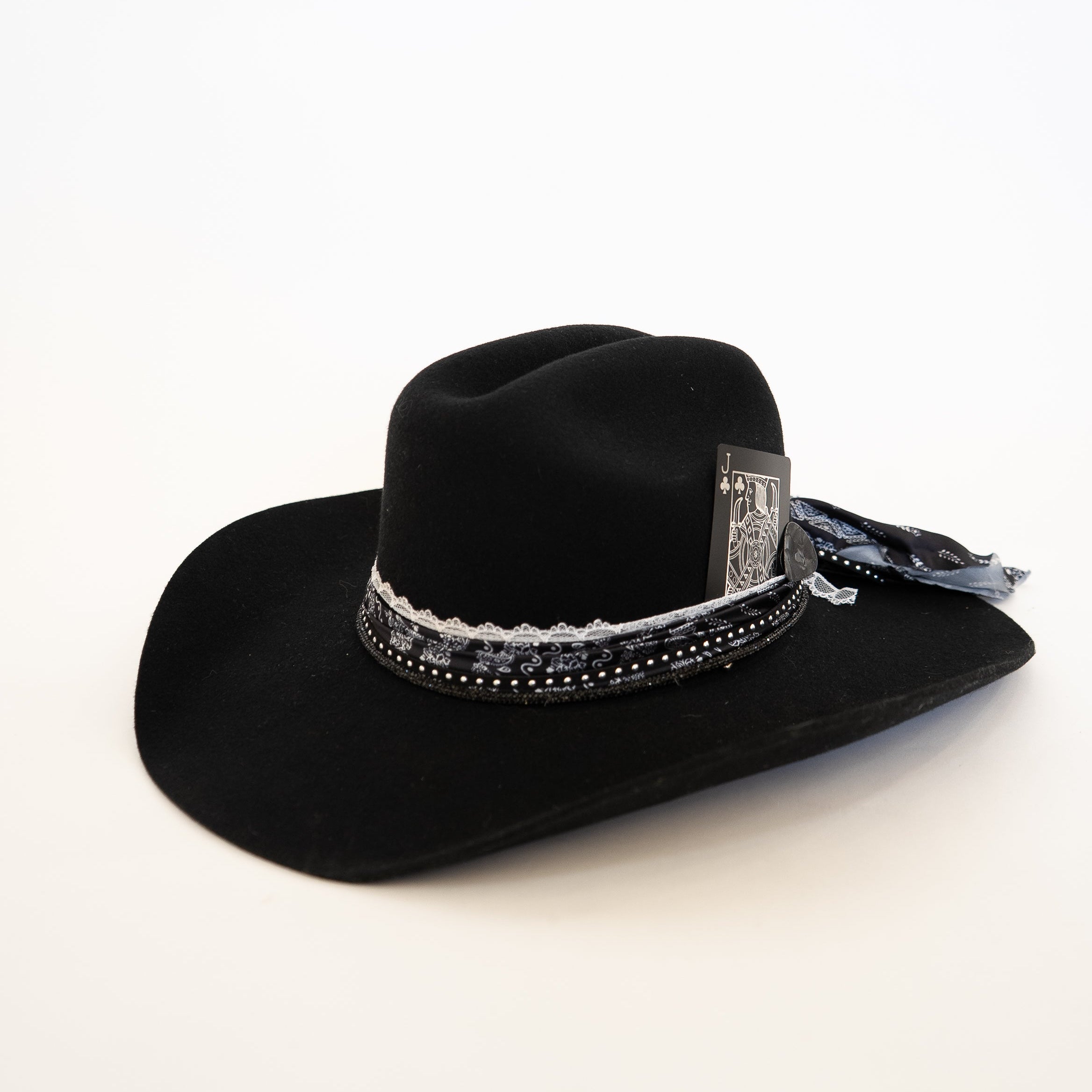 Black cowboy hat with decorative band on a white background