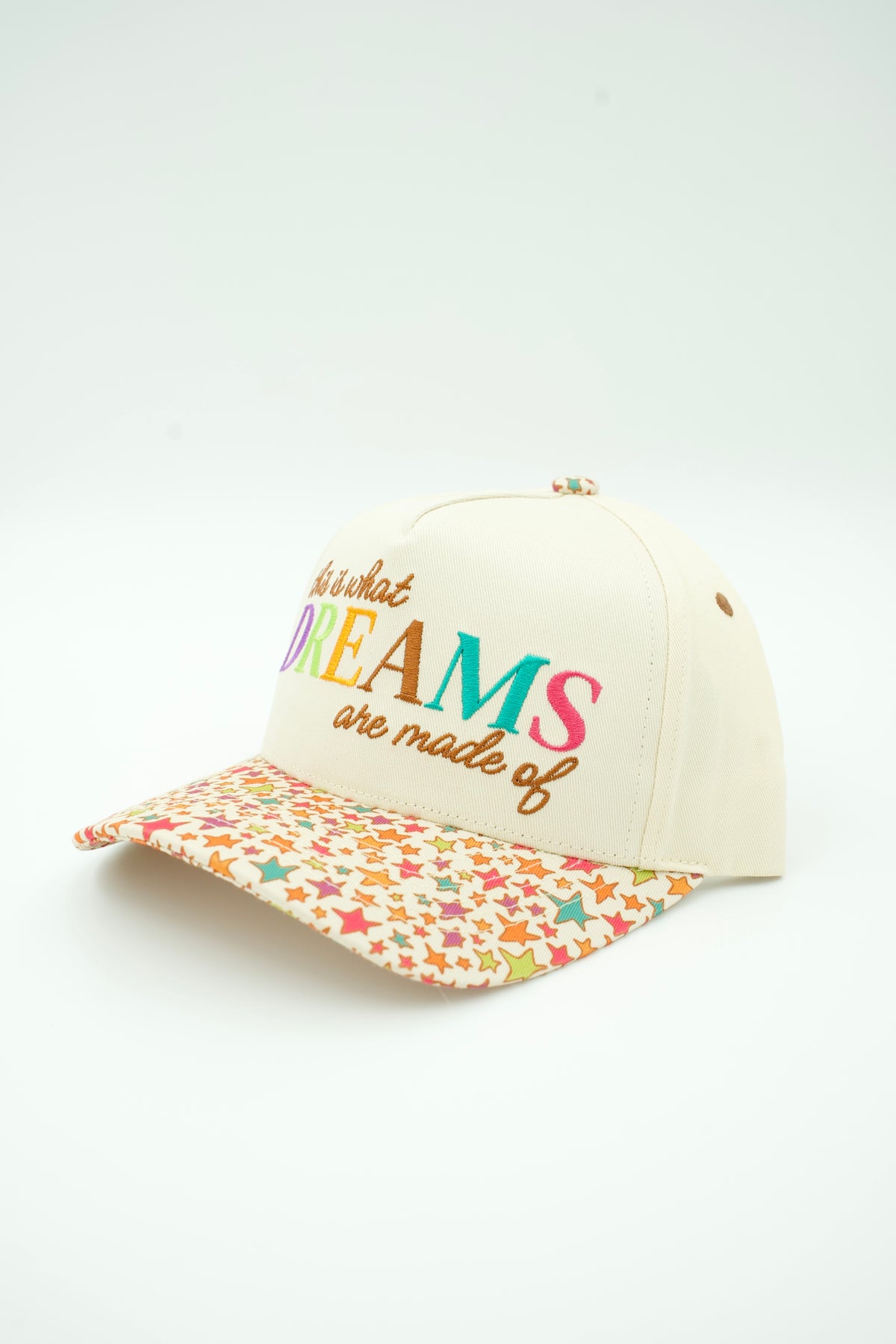 Side image of This Is What Dreams Are Made Of canvas trucker hat with multi colored stars on the bill