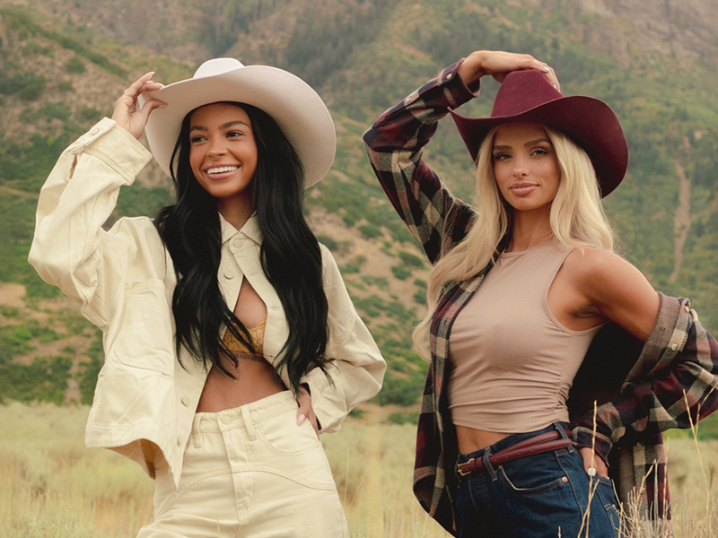 Cast members from The Secret Lives of Mormon Wives posing outdoors in their custom Rancher Hat Bar cowboy hats