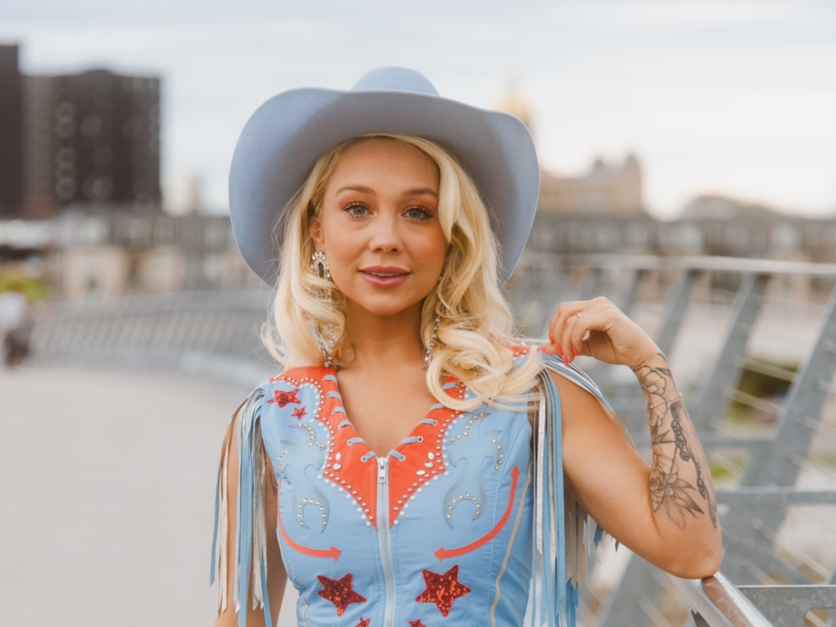 RaeLynn is wearing her custom blue Rancher Hat Bar cowboy hat that's every bit as unique as her personality