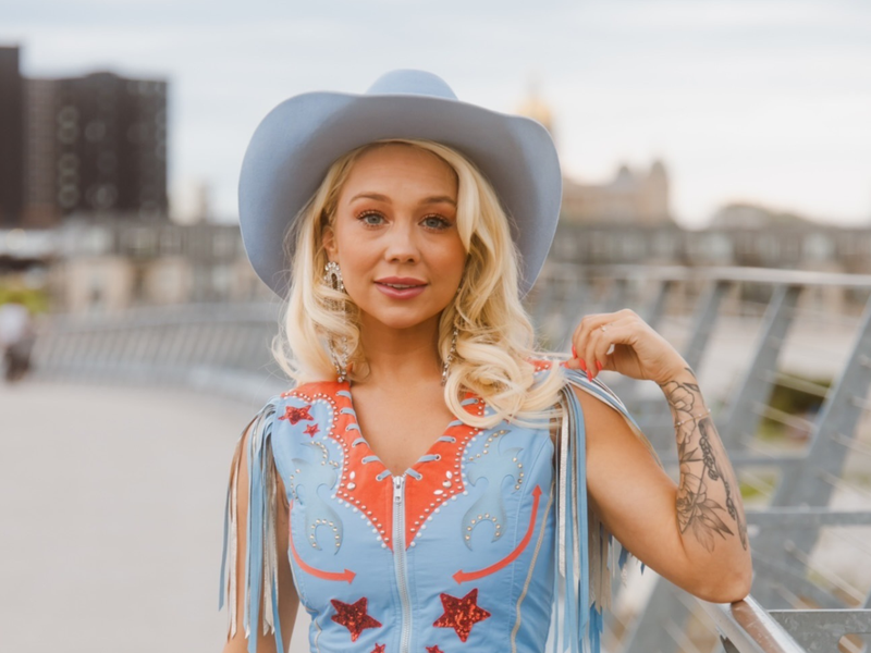 RaeLynn is wearing her custom blue Rancher Hat Bar cowboy hat that's every bit as unique as her personality