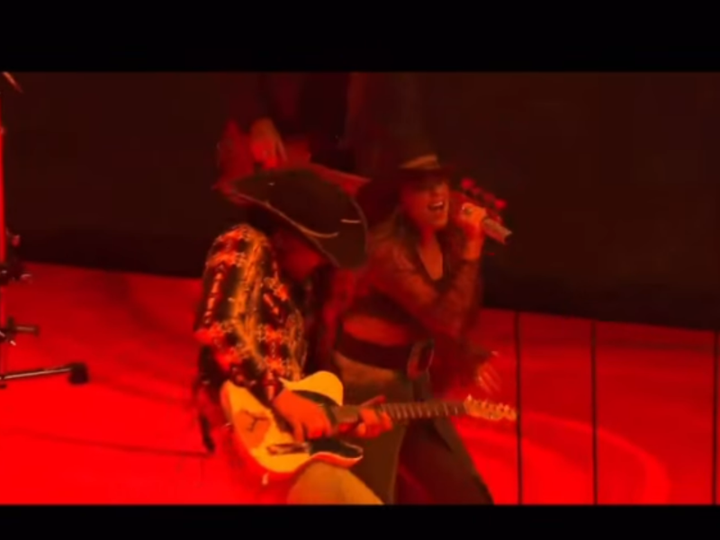 Gabby Barrett performing on stage wearing a custom Rancher Hat Bar cowboy hat