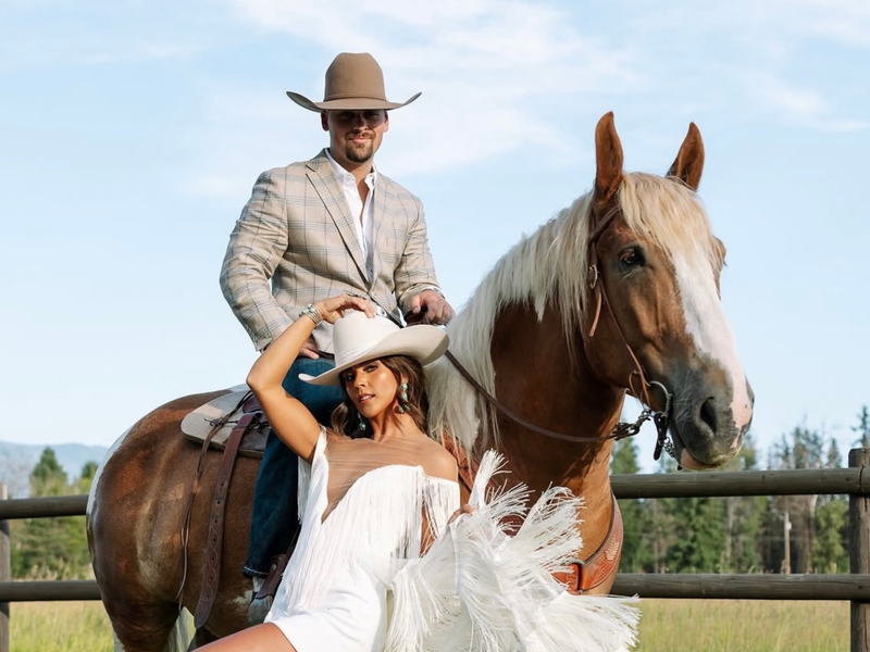 Fashion creator posing for a Rancher Hat Bar styled wedding shoot in a white custom hat with horse and a man in a cowboy hat