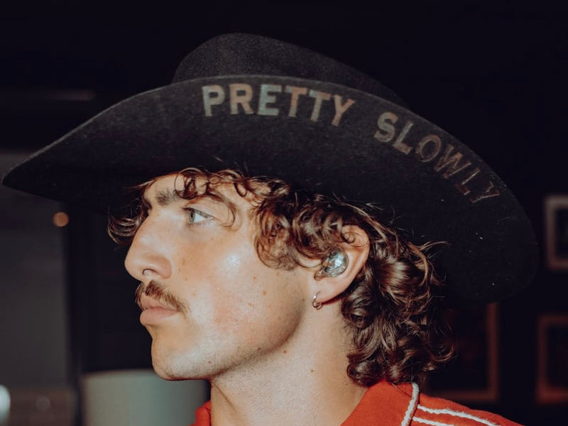 chart-topping artist Benson Boone wearing custom Rancher Hat Bar cowboy hat on stage at his concerts