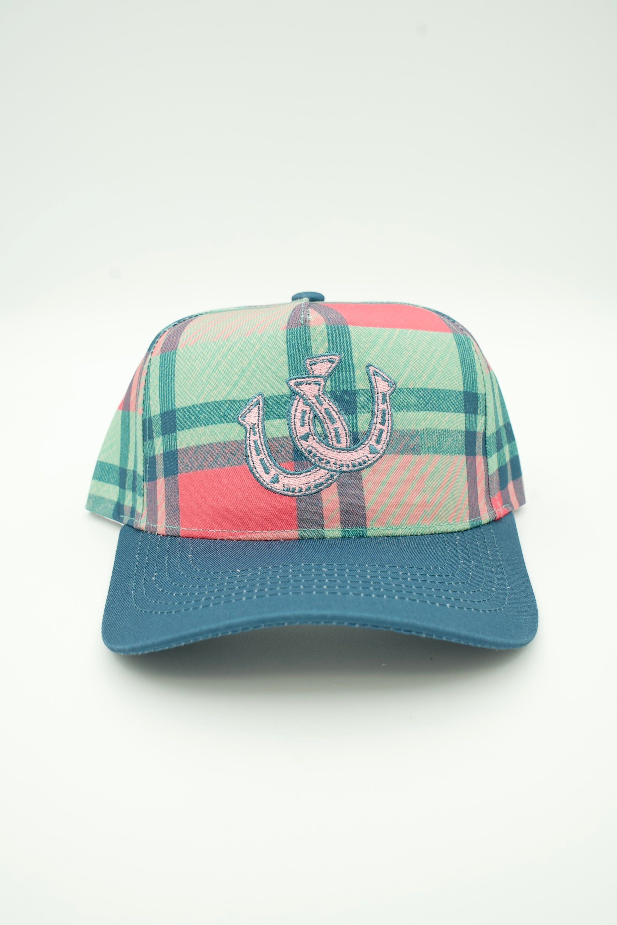 A plaid baseball cap with a teal blue brim and a central embroidered horseshoe logo, shown against a plain white background.
