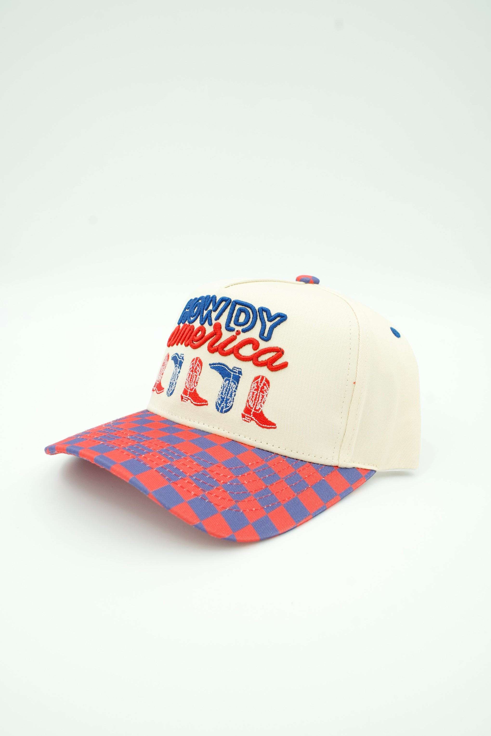 A baseball cap with an off-white crown, red and blue embroidered 'Howdy America' text, and a red and blue checkered visor, shown on a white background.