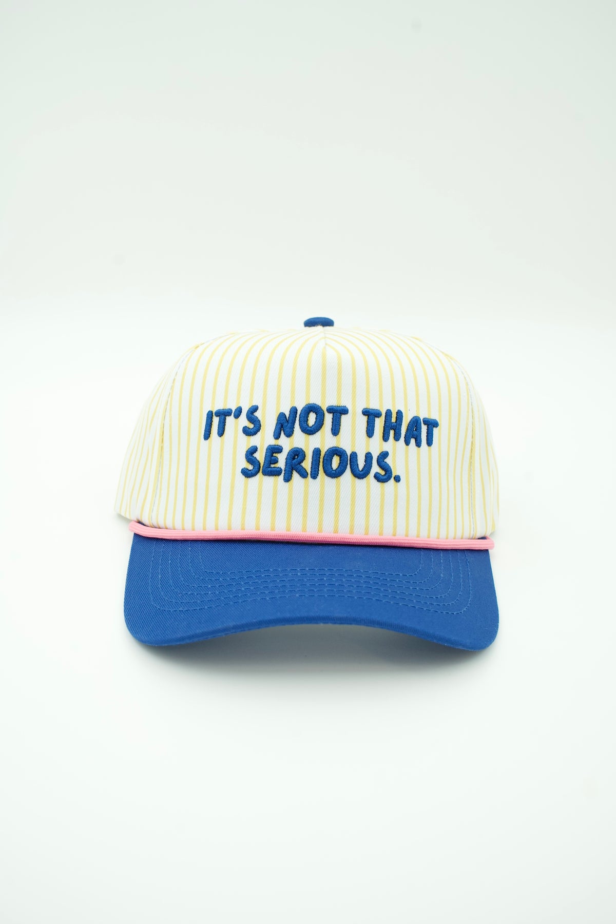 Front image of yellow striped trucker hat with IT'S NOT THAT SERIOUS embroidered on it and a blue bill