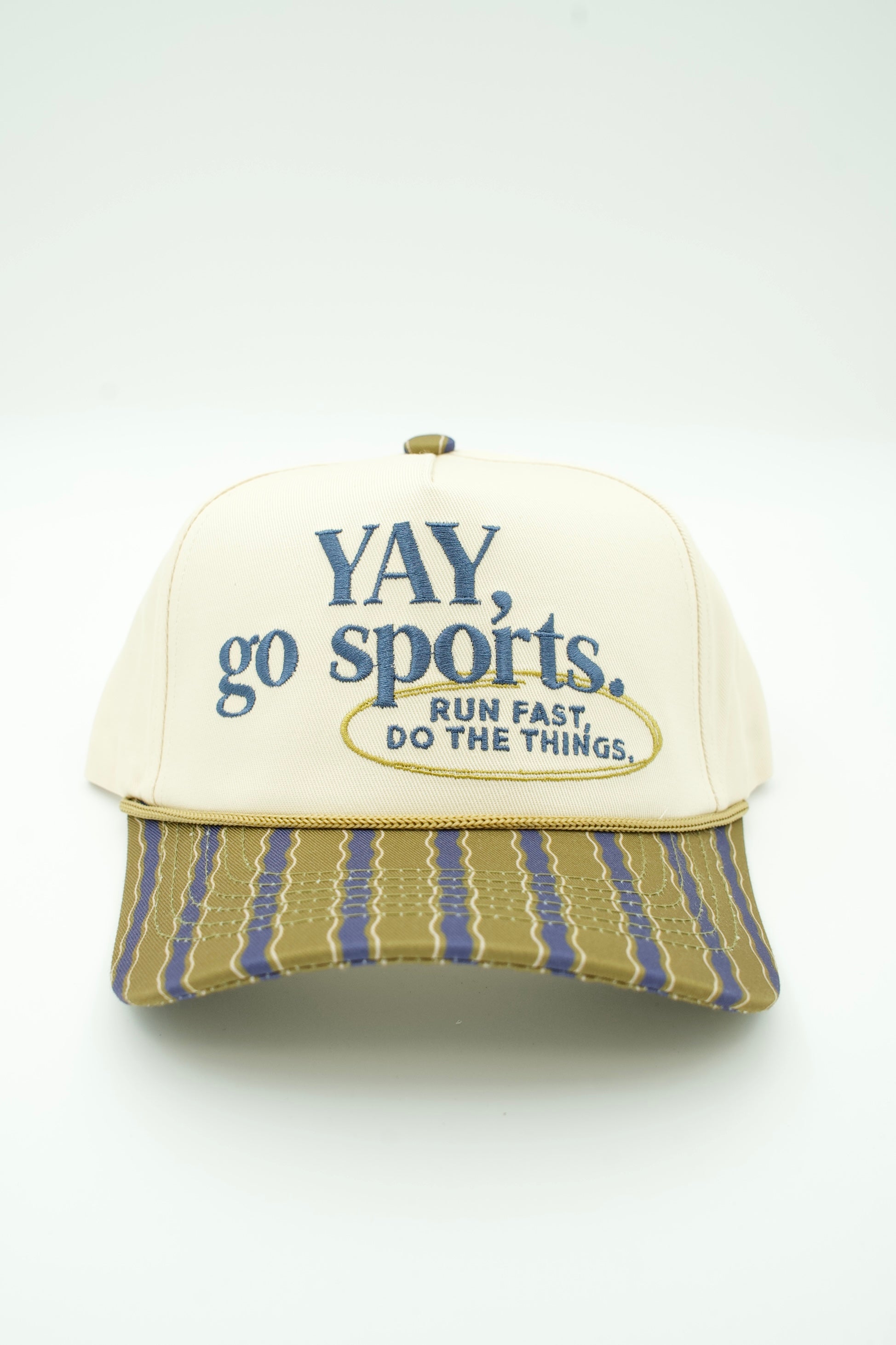 A cream-colored trucker hat with blue embroidered text reading 'YAY, go sports. RUN FAST, DO THE THINGS.
