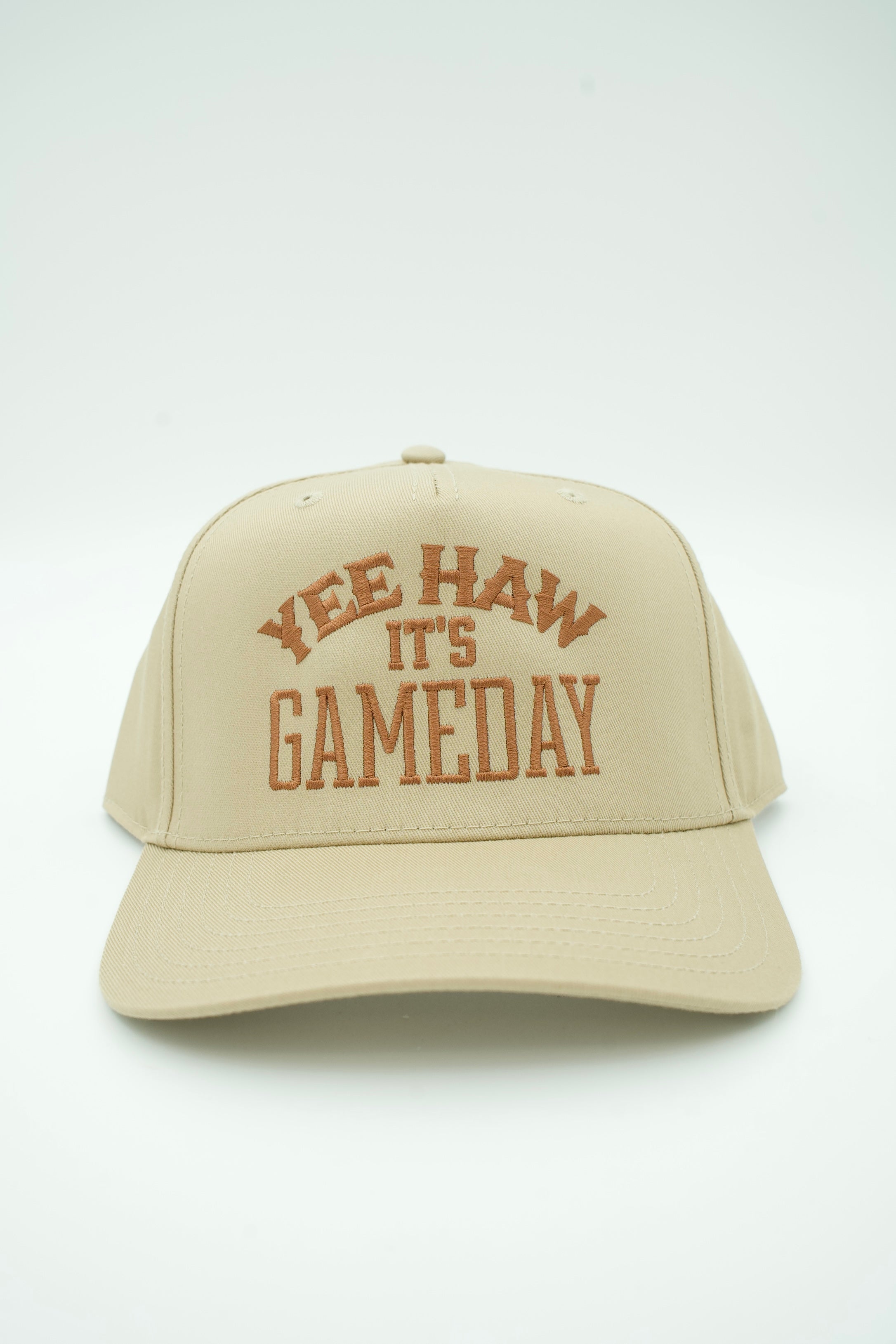 A beige baseball cap with brown embroidered text reading 'YEE HAW IT'S GAMEDAY' on the front, photographed against a plain white background.